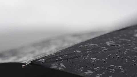 First drops of rain falling on an umbrella Video stock 129316331