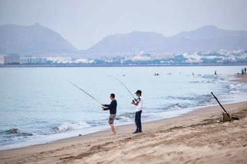 On the first evening of lockdown being lifted, two men wearing face masks set Stock Photos
