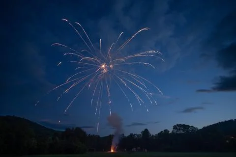 The First Firework launches in front of the sunset Stock Photos
