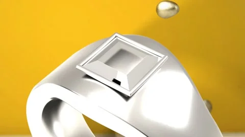 First gold droplet appearing, falling around silver ring while camera pulling Stock Footage 339448607