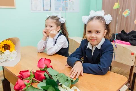 First-grade students and teacher are in school classroom at first lesson. The Stock Photos