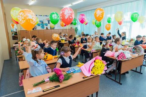First-grade students and teacher are in school classroom at first lesson. The Stock Photos
