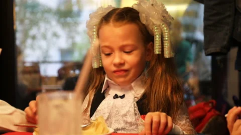 The first-grader is eating impressively in the cafe Stock Footage 106097225