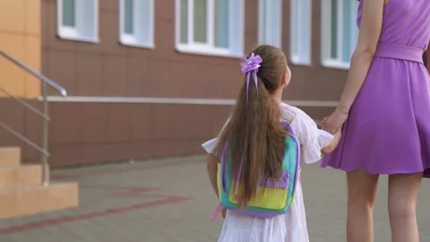 First grader goes school holding her mother hand. happy family. climb ladder Video stock 251456975