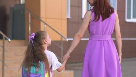 First grader goes school holding her mother hand. happy family. climb ladder Stock Footage 252292761