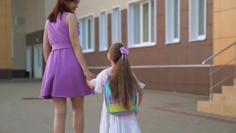 First grader goes school holding her mother hand. happy family. climb ladder Stock Footage 252653162