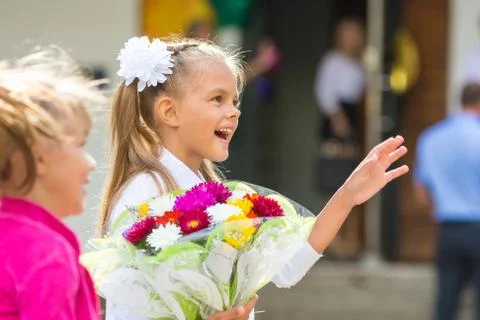 First-grader at the school the first of September in greeting waving his girl Stock Photos