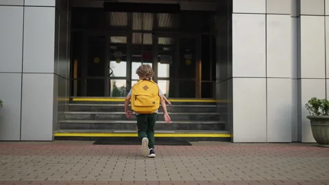 First Graders Running To School, Back View Of Little Schoolboy And Schoolgirl Stock Footage 249499040