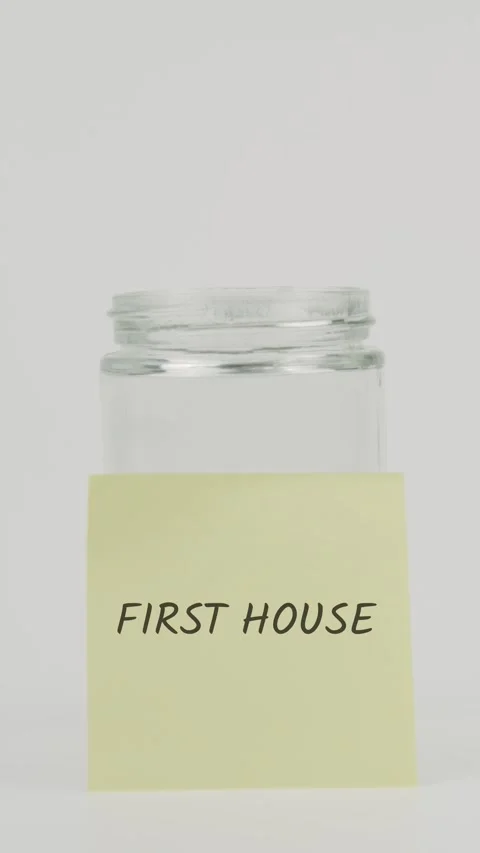 First House text or word on yellow sticky note attached to glass jar Stock Footage 311734005