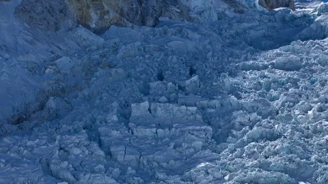 First light and shadow reveal with climbers of the Khumbu Icefall Stock Footage 122088766