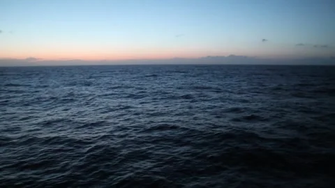First light of dawn in the middle of the sea during a crossing Stock Footage 310558392