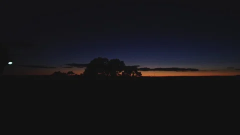 First light of day breaks over the horizon, silhouette walks toward light Stock Footage 127458639