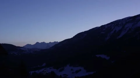 First light of the day on the snowy mountains of the Alps, in Switzerland Stock Footage 239780911