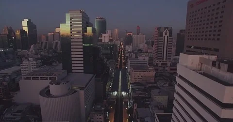 First Light Reflecting on Office Windows in Downtown Bangkok, Aerial Approach Sh Stock Footage 71678689