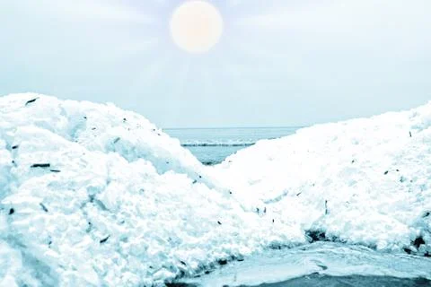 First low hummocks of rolled ice on edge of sea Stock Photos