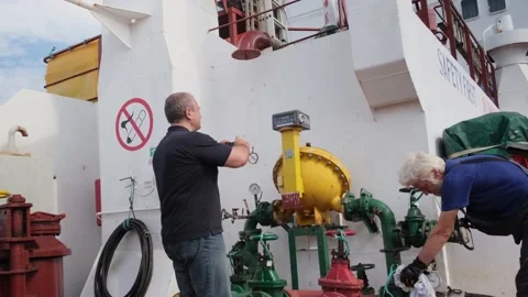 First officer and donkeyman control fuel pumping on tanker Stock Footage 140899903