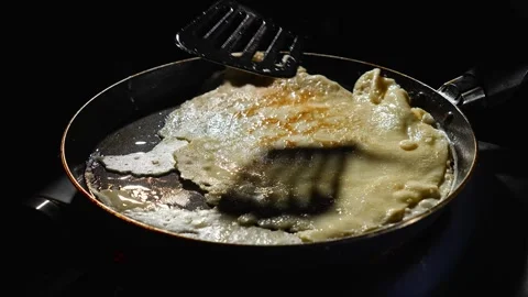 The first pancake is a failure. Unsuccessfully fried pancake is flipped on the Stock Footage 264401219