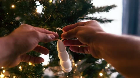 First person perspective decorating christmas tree with ornaments Stock Footage 332240404