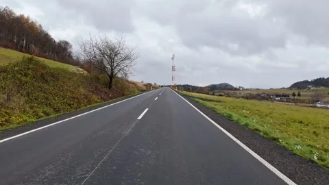First-person perspective from a drone moving along a new road, cell tower i.. Stock Footage 258567124