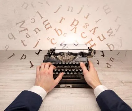 First person perspective elegant hand typing with flying letters concept Stock Photos