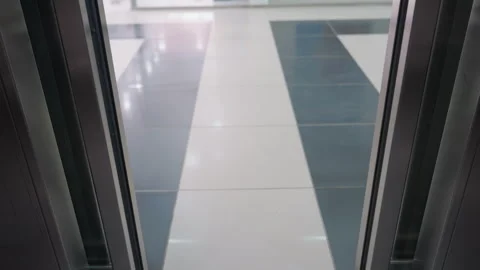 First-Person Perspective of Elevator Doors Opening in a Modern Building Stock Footage 281363831