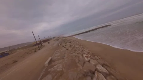 First-person perspective riding along beach path with waves Video stock 345051063