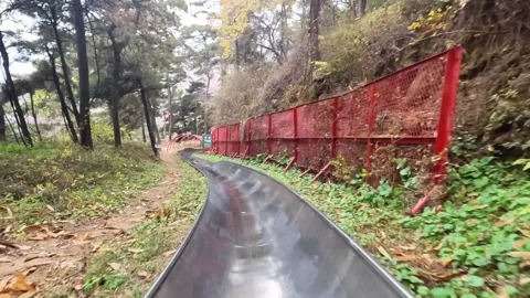 First person perspective view of tourist sliding down from Great Wall on 스톡 동영상 345960897