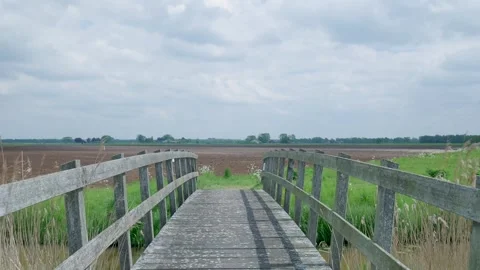 First person perspective walking across a rustic wooden bridge 스톡 동영상 336845729