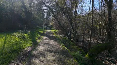 First-person perspective of walking along a stone path in the Corgo river c.. Foto stock