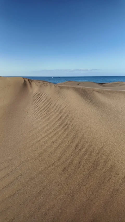 First person perspective walking on sand dunes revealing the ocean Stock Footage 346177733