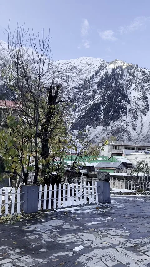 First-person perspective  on a wet stone path toward snowy mountains Stock Footage 329321992