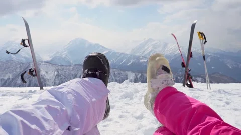 First-person point of view looking at legs, boots of skier snowboarder sitt.. Stock Footage 342112638