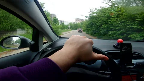 First person point of view man driving car by city roads Stock Footage 220252923