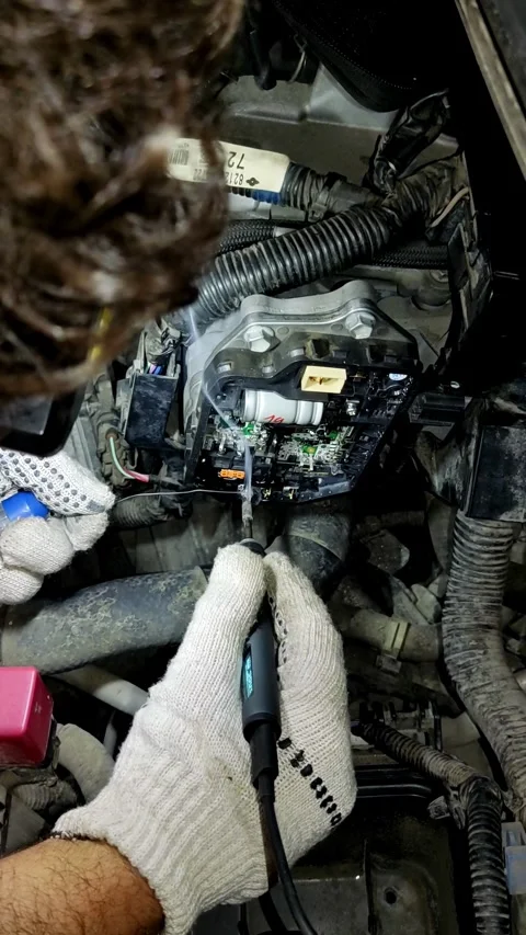 First-person point-of-view shot soldering car electronic board inside engine Stock Footage 337431580