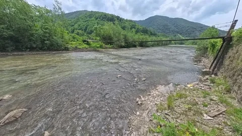 First-person POV perspective looking across a narrow wooden suspension bridge Vídeo Stock 346182069