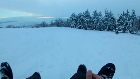 First Person POV Of Sledding Down Snowy Hill Showing Winter Boots 스톡 동영상 344196309