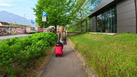 First person POV slow motion shot of a woman walking with a trolley through Stock Footage 309567566