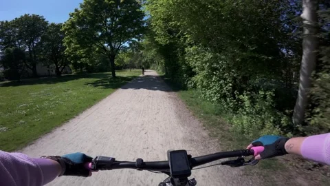 First person POV video of fast riding an electric mountain bike on a gravel path Stock Footage 337657165