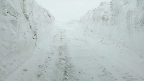 First-person shooting, walking through a deep ditch of snow Stock Footage 172237878