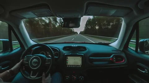 First person slow motion in the passenger seat of a car driving on a day road Stock Footage 243608310