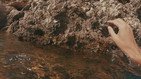 First person video, man climbs up coastal rock and looks around Stock Footage 252208077