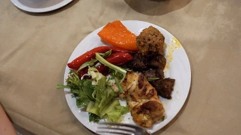 A first-person view and a point of viewing a person who eats meat and vegetab Stock Footage 93434018