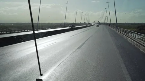 First person view from a bus front seat in the morning on wet highway Stock Footage 273673742