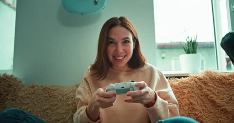 First person view of a cheerful and interested brunette girl impulsively playing Stock Footage 280258790