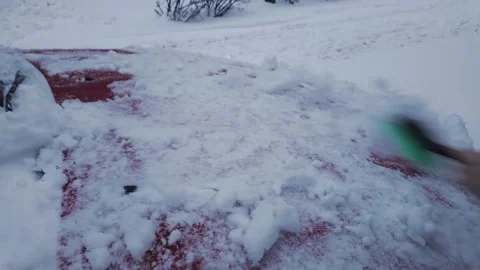 First Person View Clearing Heavy Snow From Red Car Windshield On Winter Morning Stock Footage 340119903