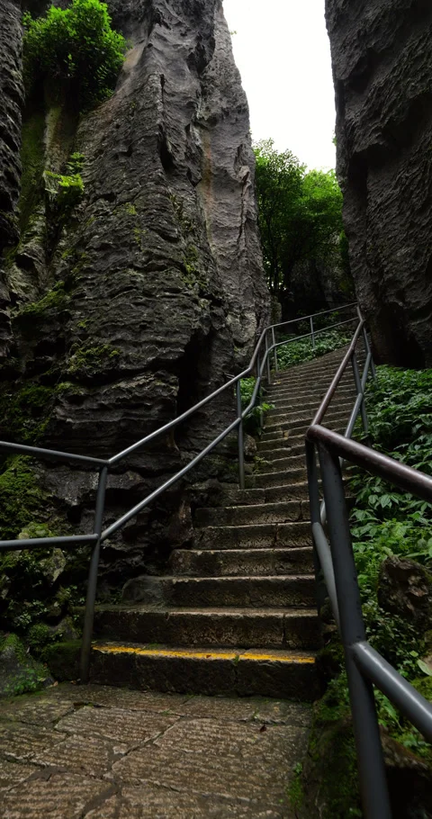 First person view climbing steep stairs at Shilin Stone Forest Stock Footage 329622995