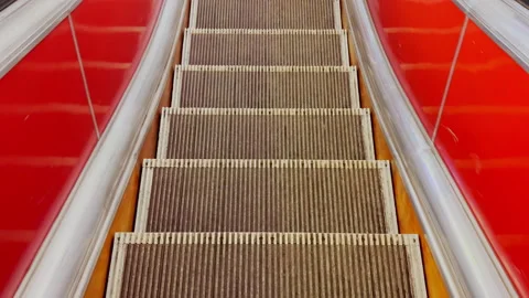 First person view of close up footage of moving empty escalator stairs Stock Footage 169415416