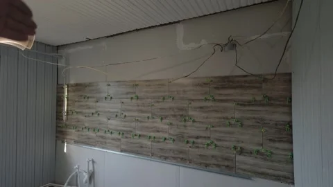 First-person view of a contractor explaining the tiling process on a drywall Stock Footage 319918857