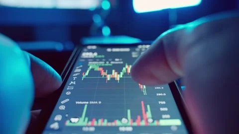 First-person view of cryptocurrency charts on a mobile phone. Stock Footage 242694816