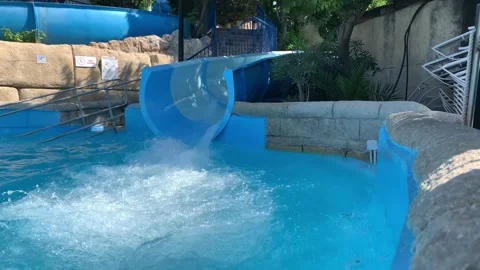 First-person view, the descent from the waterslide on holiday aqua park water fa Stock Footage 208338155